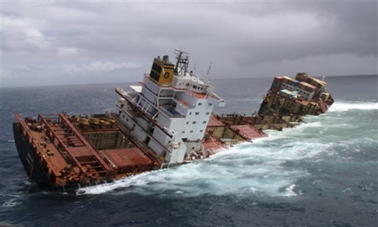 The cargo ship Rena is split in two and sits on a reef near Tauranga, New Zealand, Monday, Jan. 9. The Greek-owned Rena ran aground on Astrolabe Reef 14 miles (22 kilometers) from Tauranga Harbour Oct. 5, 2011, spewing heavy fuel oil into the seas in what has been described as New Zealand's worst maritime environmental disaster.